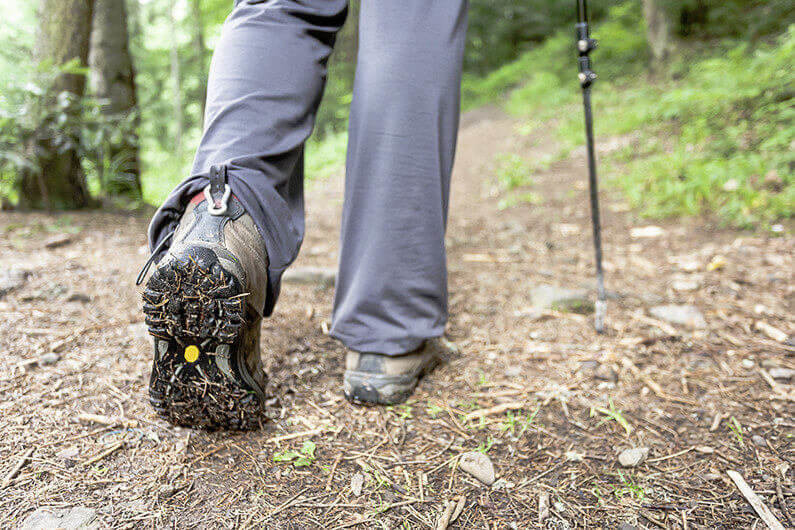 Close view of hiker boots, travel background.