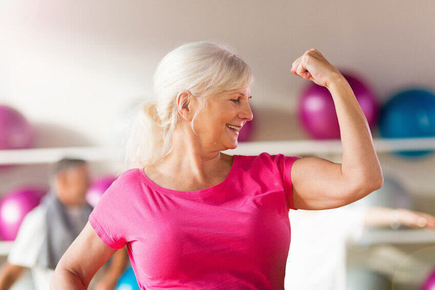 Confident mature woman showing off her bicep