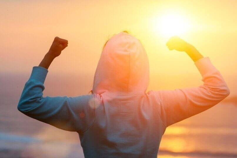 Celebrating fitness workout success towards the sun