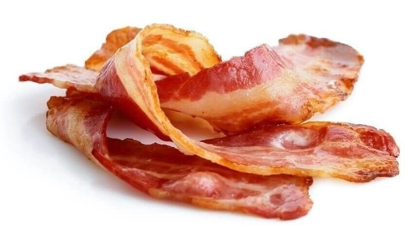 Three strips of fried crispy bacon isolated on white.