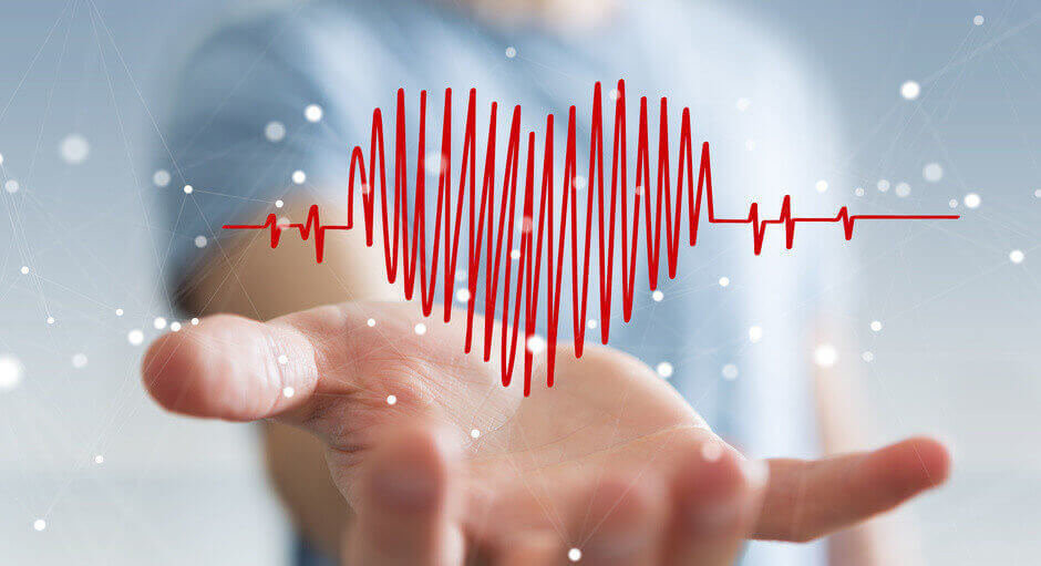 Businessman on blurred background touching and holding heart beat sketch