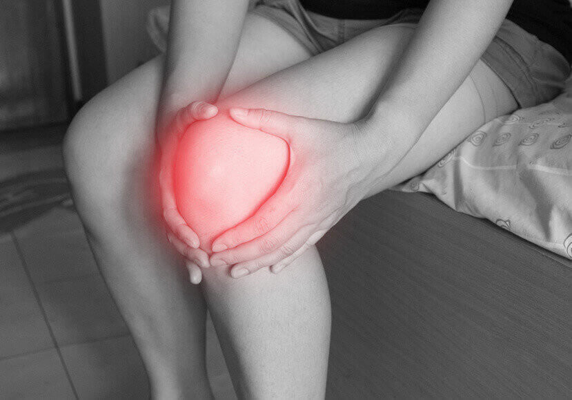 women has inflammation and swelling cause a pain the sore knee, sport physical injuries when working out.