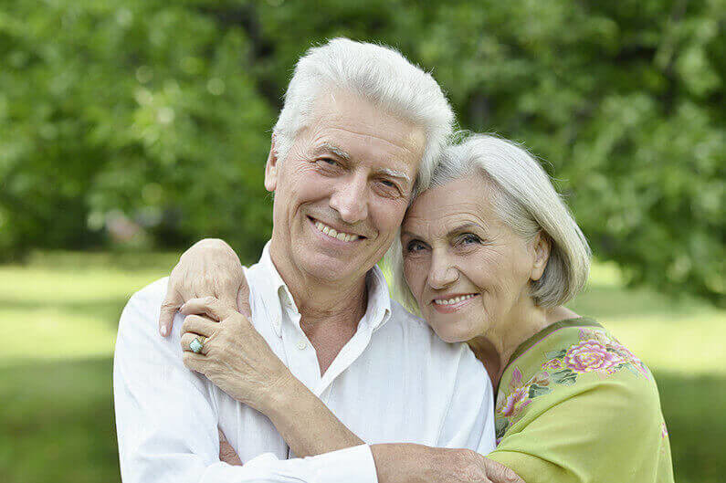 Loving mature couple in a summer park