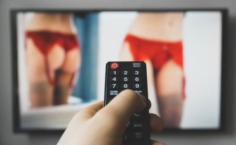 Man watching adult erotic movie on TV.