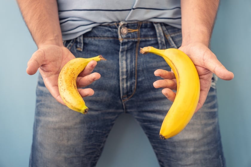 Small Banana compare size wish banana on blue background. Sexual life libido, penis size and potency concept. top view, copy space