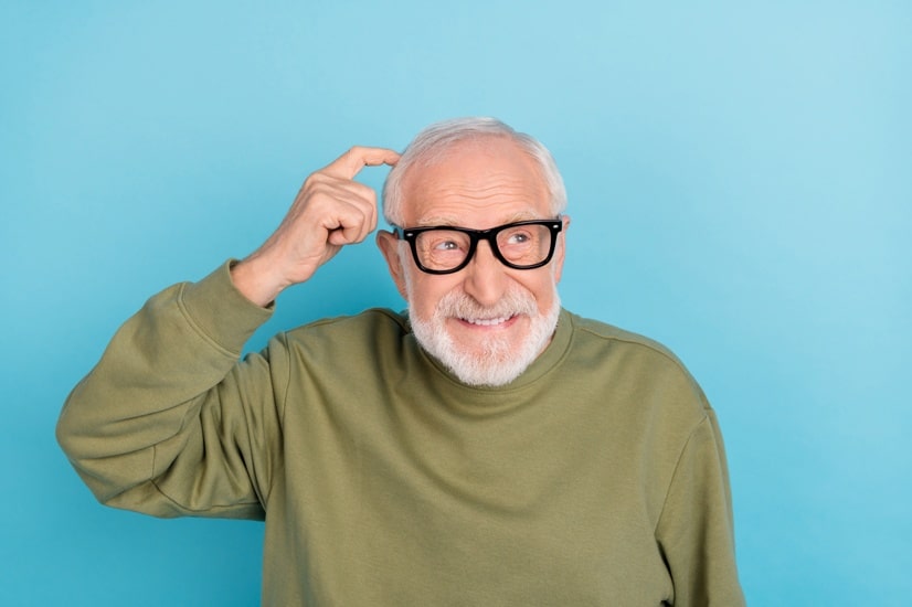 Portrait of attractive minded cheerful grey-haired man geek making decision isolated over bright blue color background