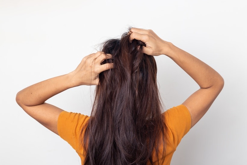 Women itching scalp itchy his hair and was massage her hair on a white background,Haircare concept