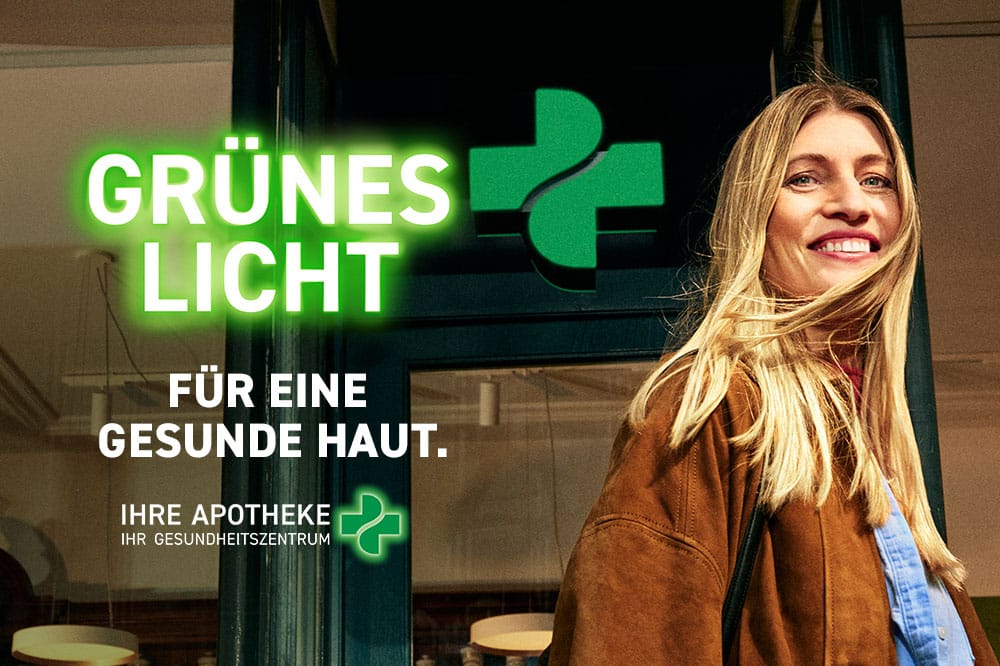 Frau steht vor einer Apotheke