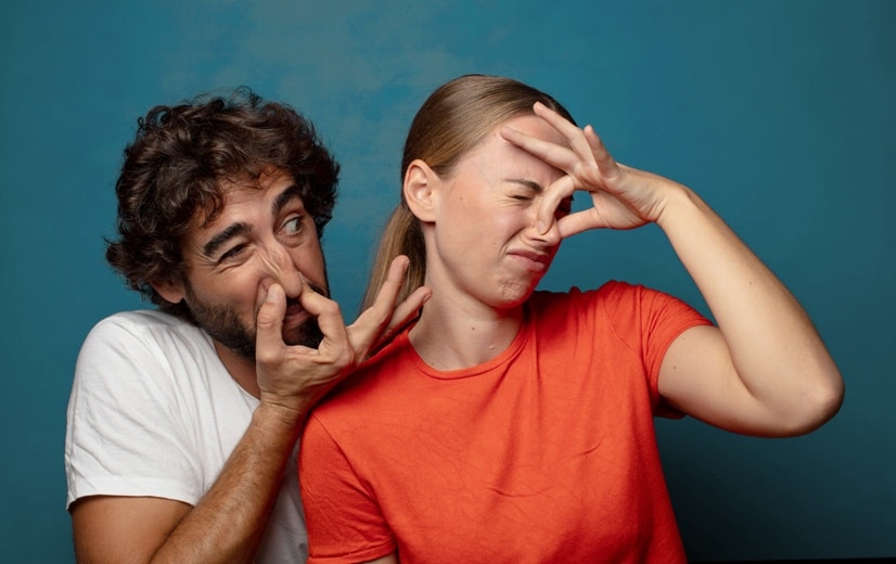 feeling disgusted, holding nose to avoid smelling a foul and unpleasant stench