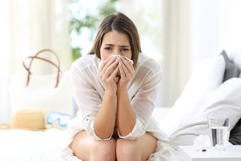 Ill allergic woman looking at you on vacations