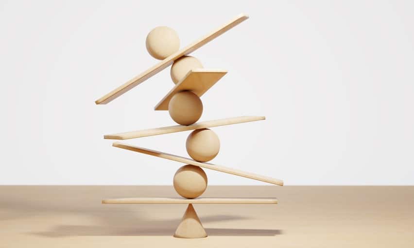 Wooden spheres balancing on seesaw. Concept of harmony and balance in life and work
